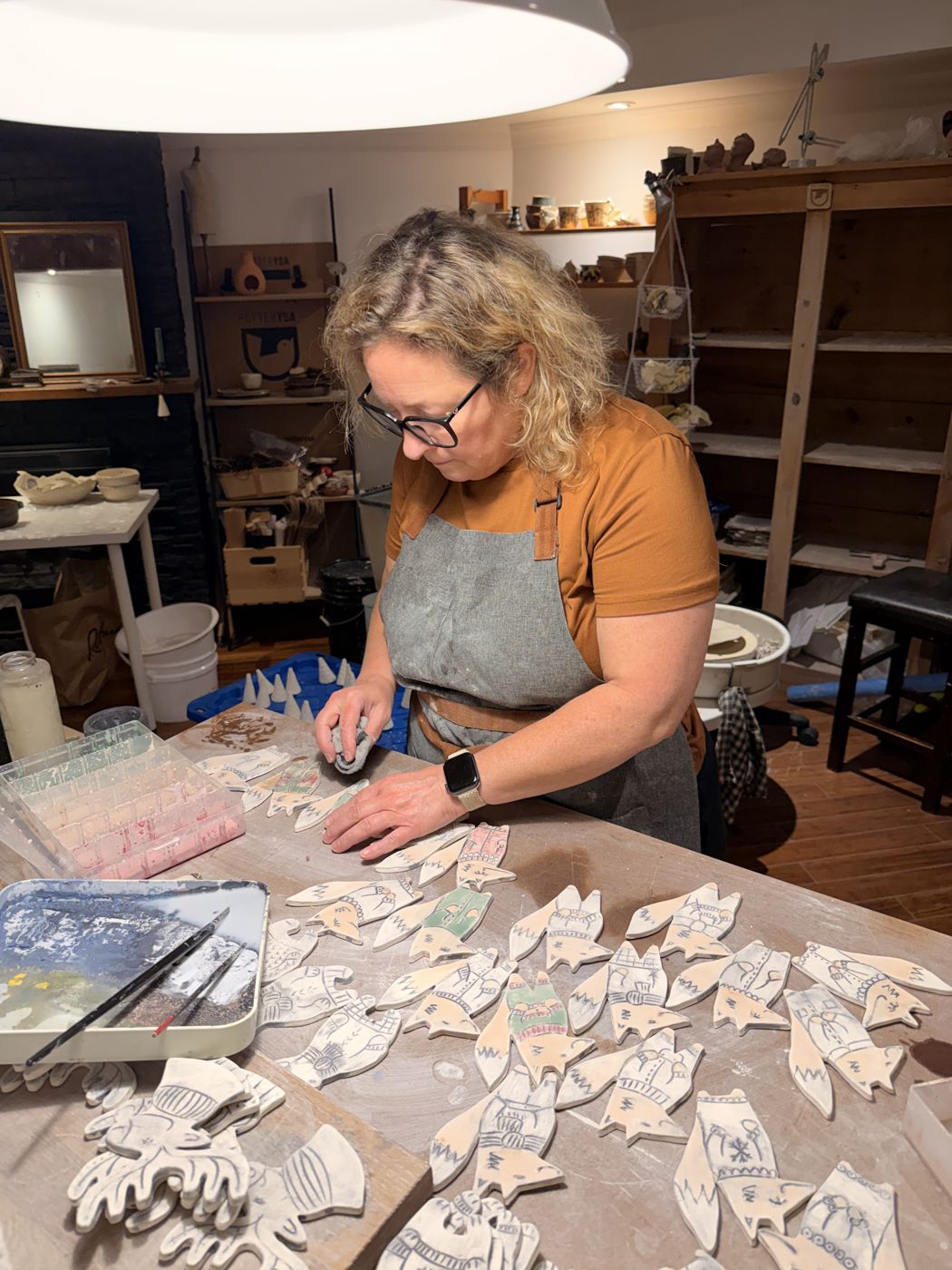 Ysabel decorating small pieces in the studio